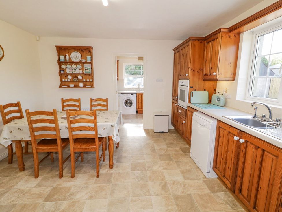 A kitchen with a table and chairs at Craiglea Lodge in Coleraine