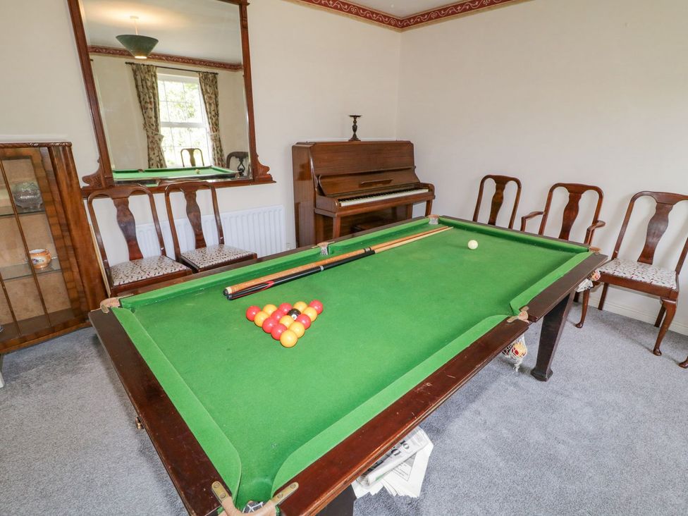 A game room with a billiard table and piano at Craiglea Lodge in Coleraine
