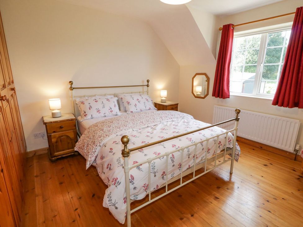 A bedroom with a bed and bedside tables at Craiglea Lodge in Coleraine