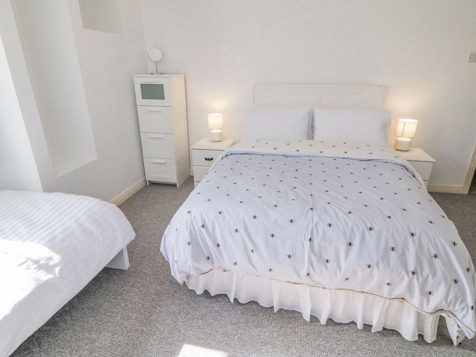 A bedroom with a double bed and single bed at Craiglea Lodge in Coleraine