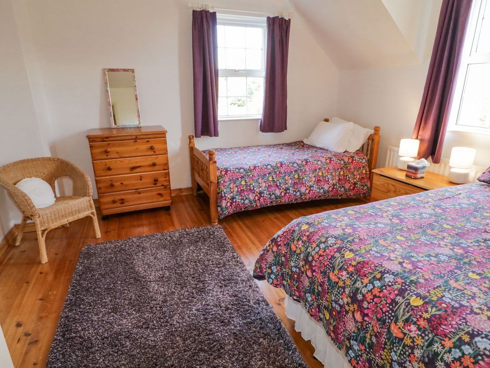 A bedroom with two beds and a dresser at Craiglea Lodge in Coleraine