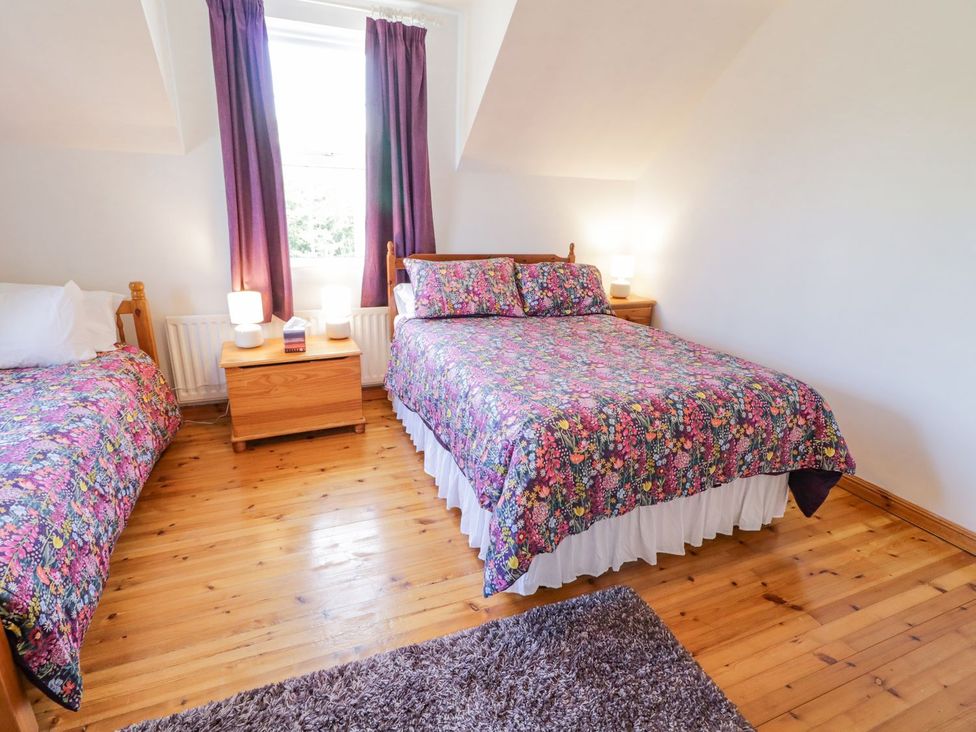 A bedroom with a double bed and a single bed at Craiglea Lodge in Coleraine