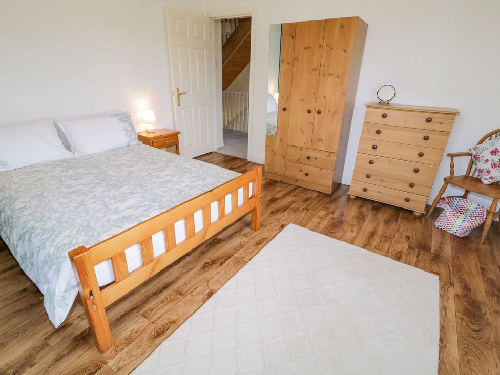 A bedroom with a bed and furniture at Craiglea Lodge in Coleraine