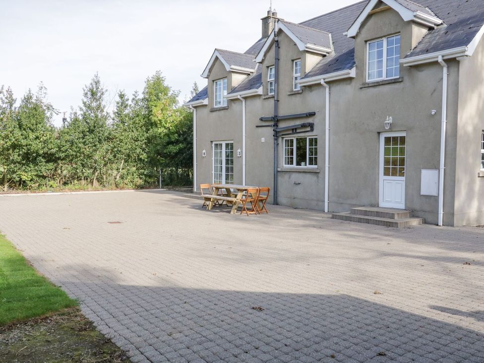 An outdoor area with a house and dining setup at Craiglea Lodge in Coleraine