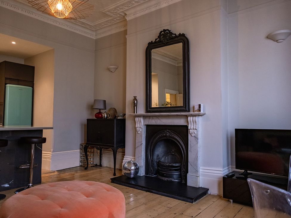 A living room with a fireplace and television at Gorgeous 2Bed Apartment with Patio Brighton And Hove
