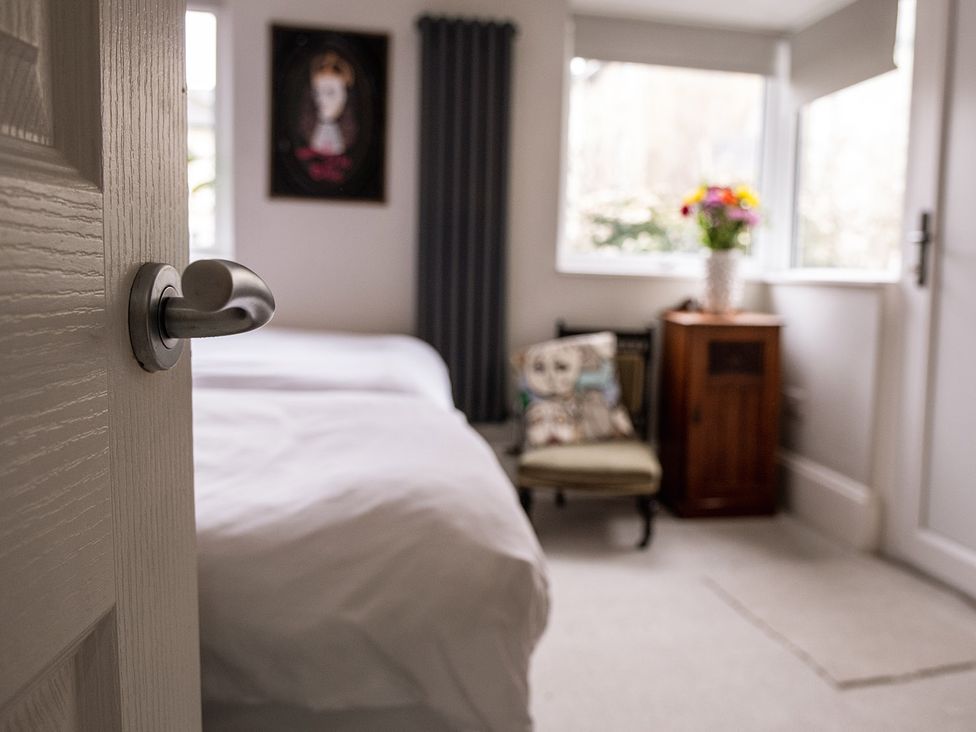 A bedroom with a bed and a chair at Gorgeous 2Bed Apartment with Patio in Brighton And Hove