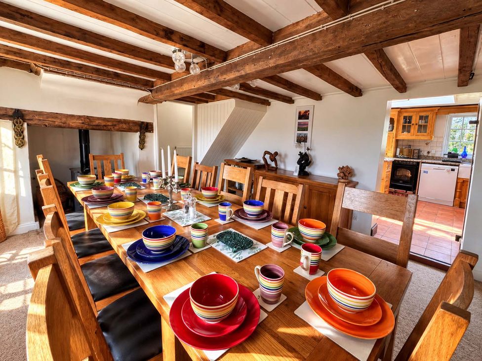 A dining room with a large table set for a meal at Holdfast Cottage Sleeps 12 in The New Forest, Bramshaw near Totton, Hampshire