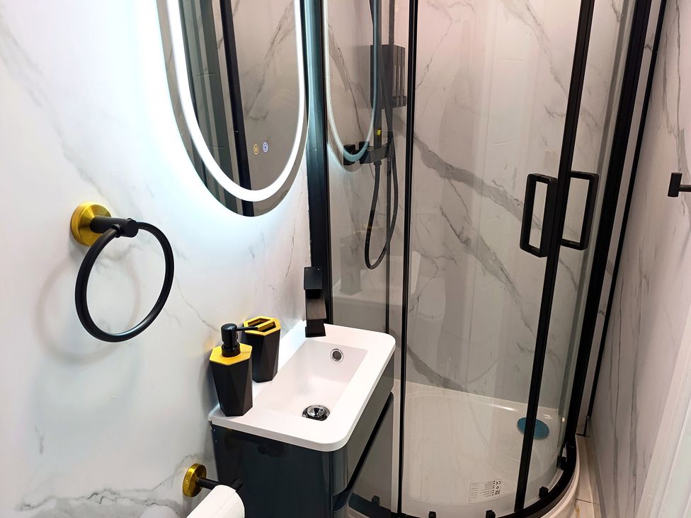 A bathroom with a sink and shower at Cardiff Cozy One Bedroom Apartment in Cardiff