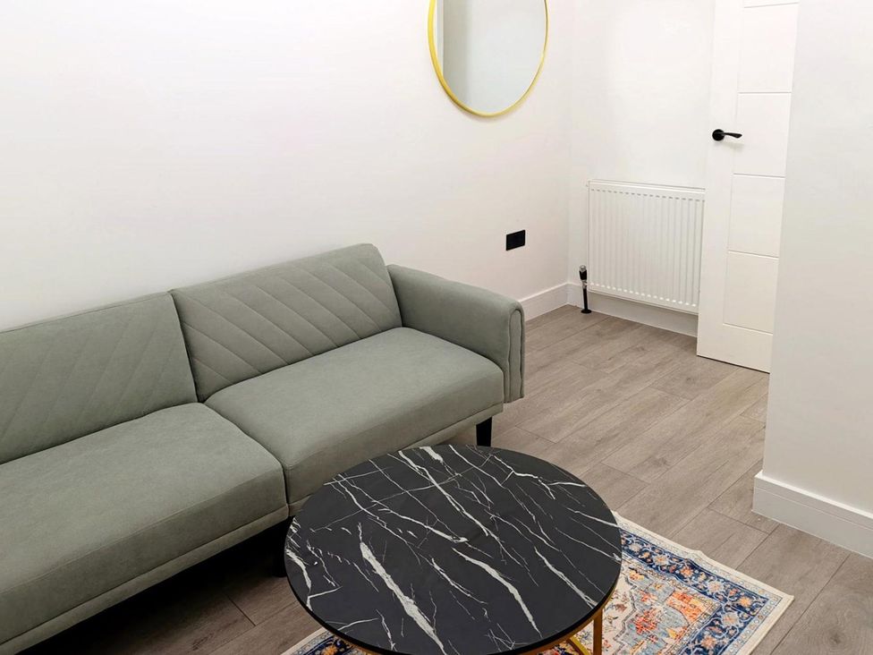A living room with a sofa and a coffee table at Cardiff Cozy One Bedroom Apartment in Cardiff