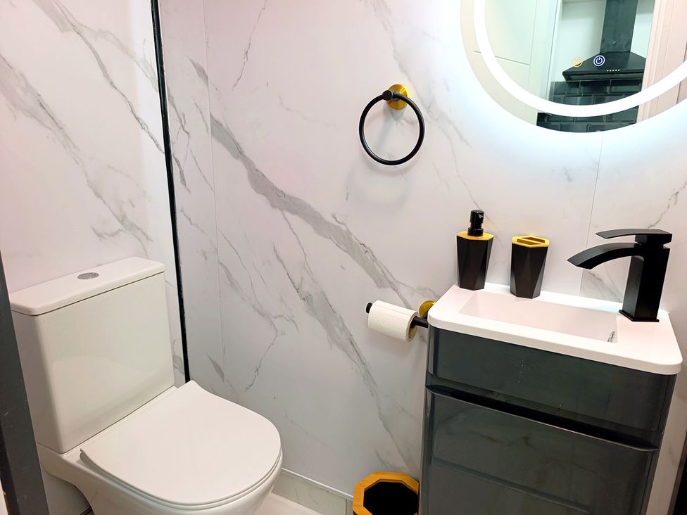 A bathroom with a toilet and sink at Cardiff Cozy One Bedroom Apartment in Cardiff