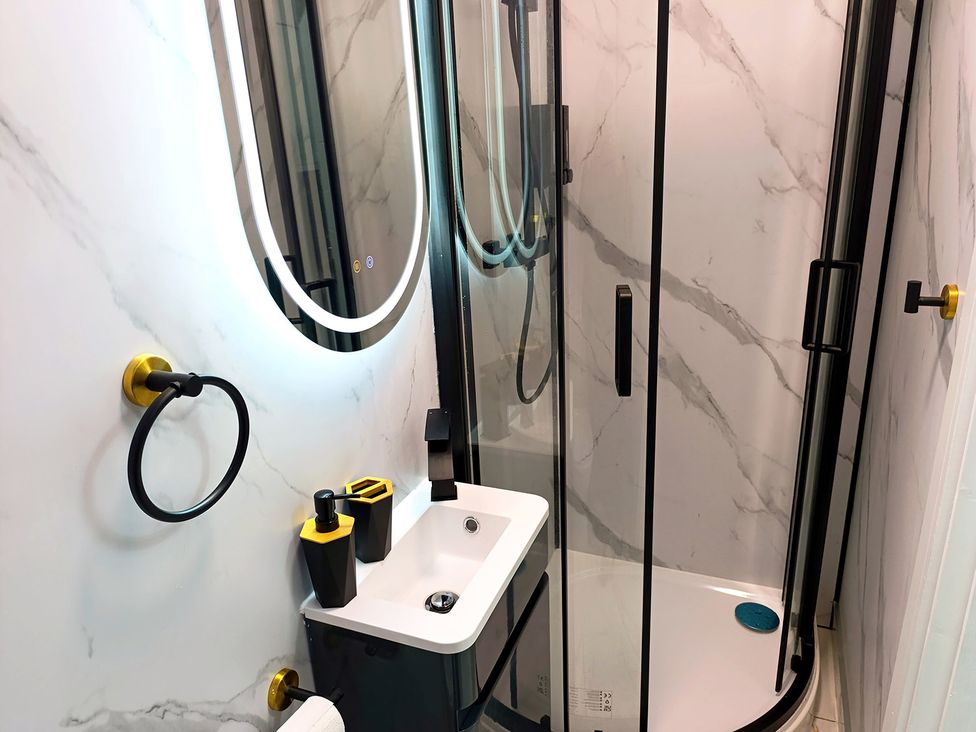 A bathroom with a shower and sink at Cardiff Cozy One Bedroom Apartment in Cardiff