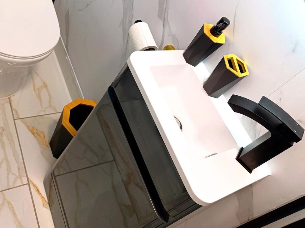 A sink and toilet in a bathroom at Cardiff Cozy One Bedroom Apartment in Cardiff