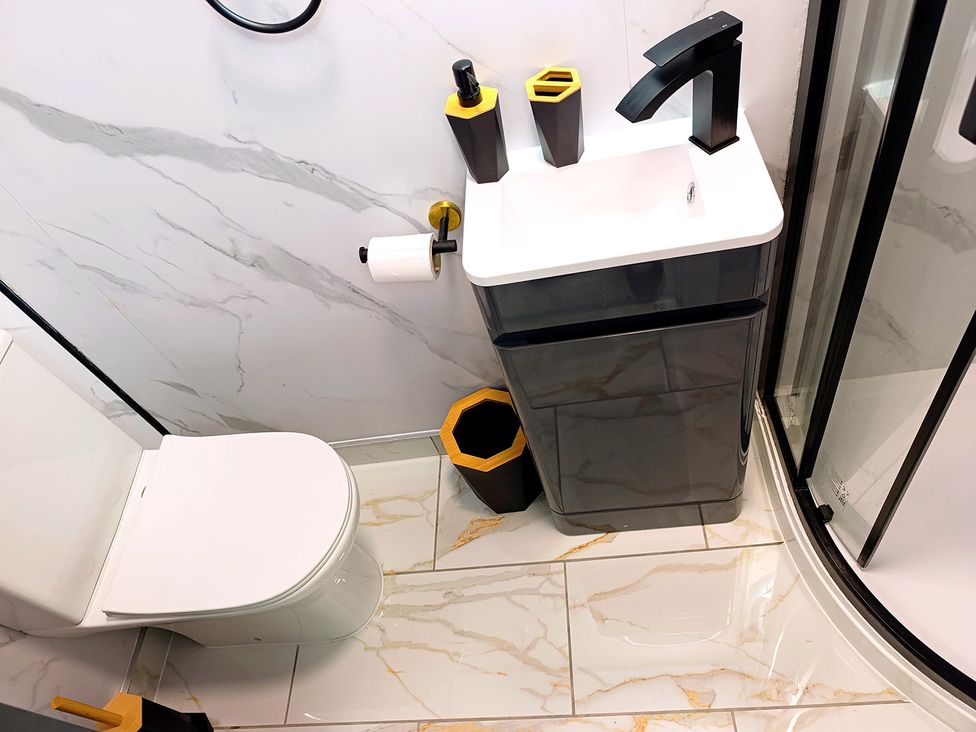 A bathroom with a toilet and sink at Cardiff Cozy One Bedroom Apartment in Cardiff