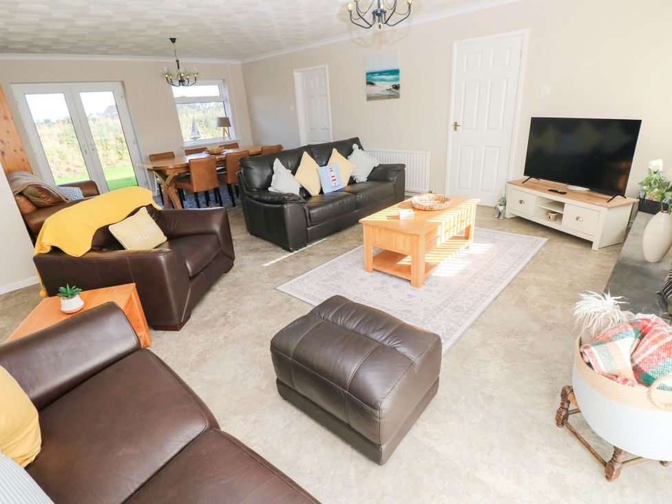 A living room with seating and a dining area at 24 Little Castle Grove, Hubberston