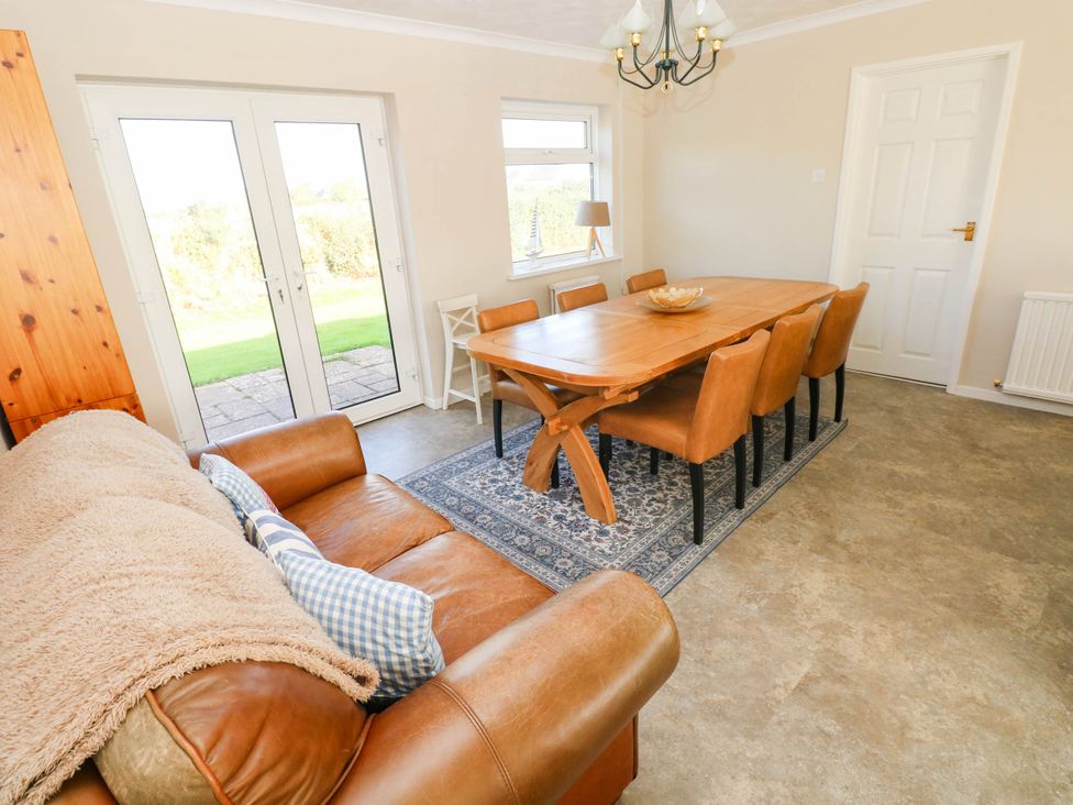 A dining room with a large table and chairs at 24 Little Castle Grove in Hubberston