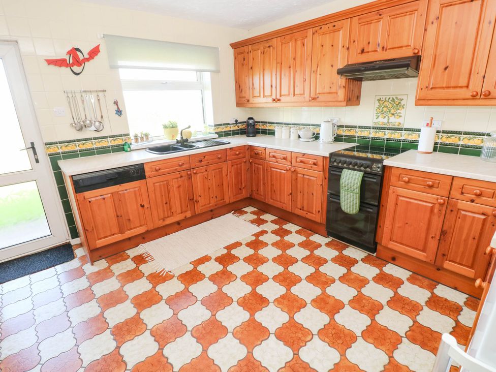 A kitchen with wooden cabinets and appliances at 24 Little Castle Grove Hubberston