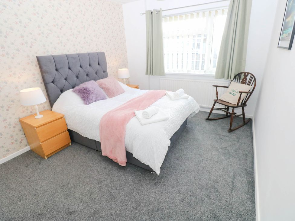 A bedroom with a bed and nightstands at 24 Little Castle Grove in Hubberston