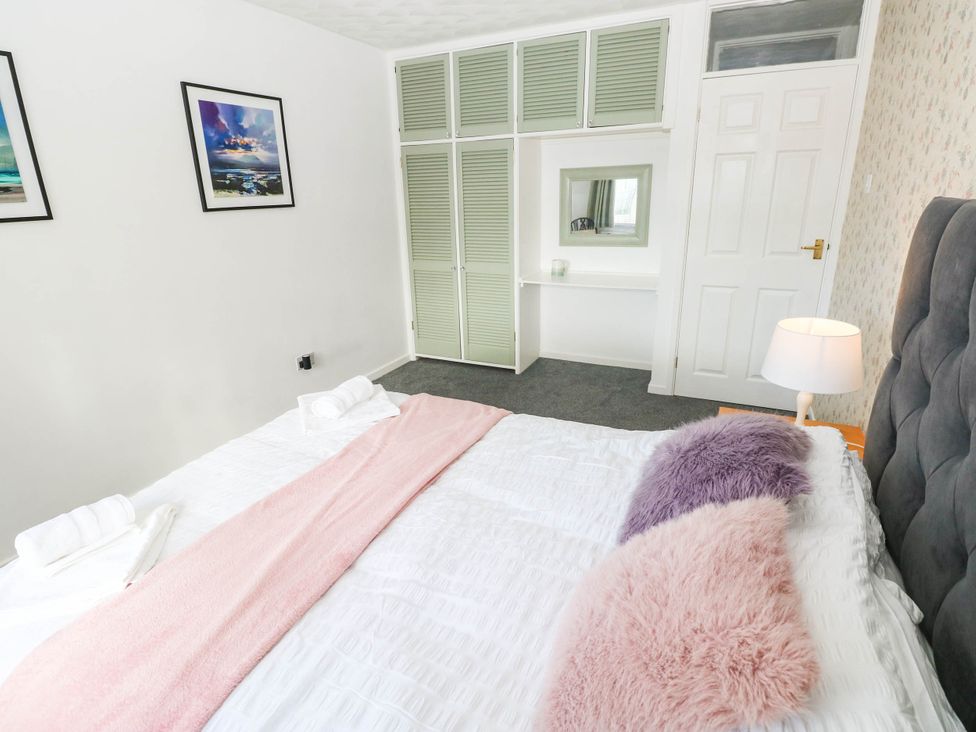 A bedroom with a bed and a cabinet at 24 Little Castle Grove in Hubberston