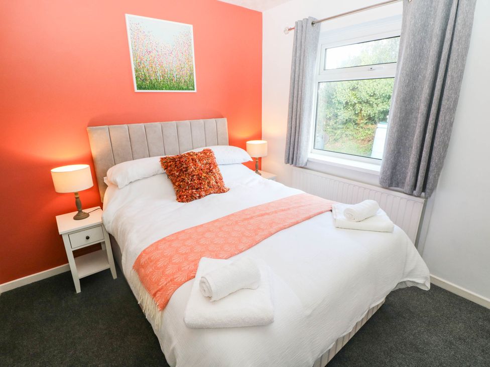 A bedroom with a bed and nightstand at 24 Little Castle Grove in Hubberston