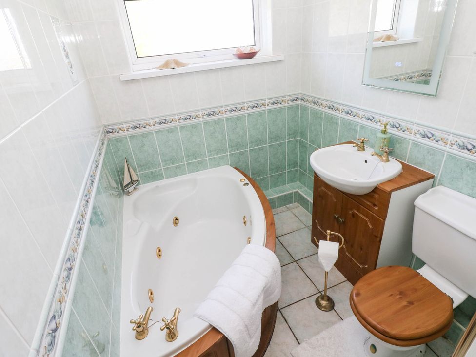 A bathroom with a bathtub and sink at 24 Little Castle Grove in Hubberston