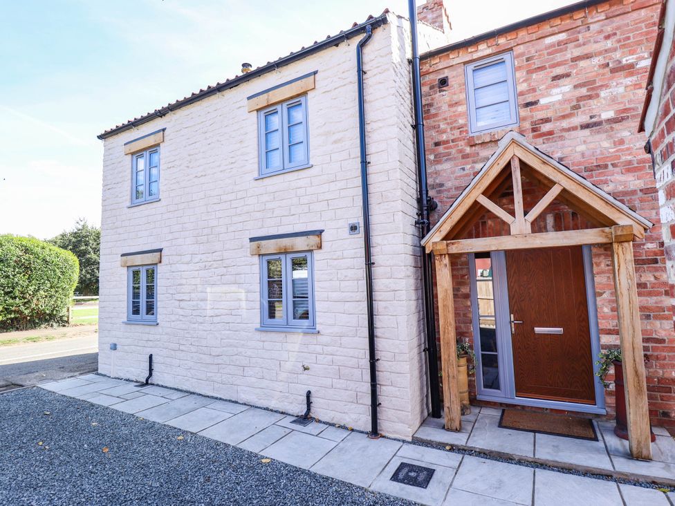 A house with a porch and pathway at Three Chimneys in Scampton near Ingham