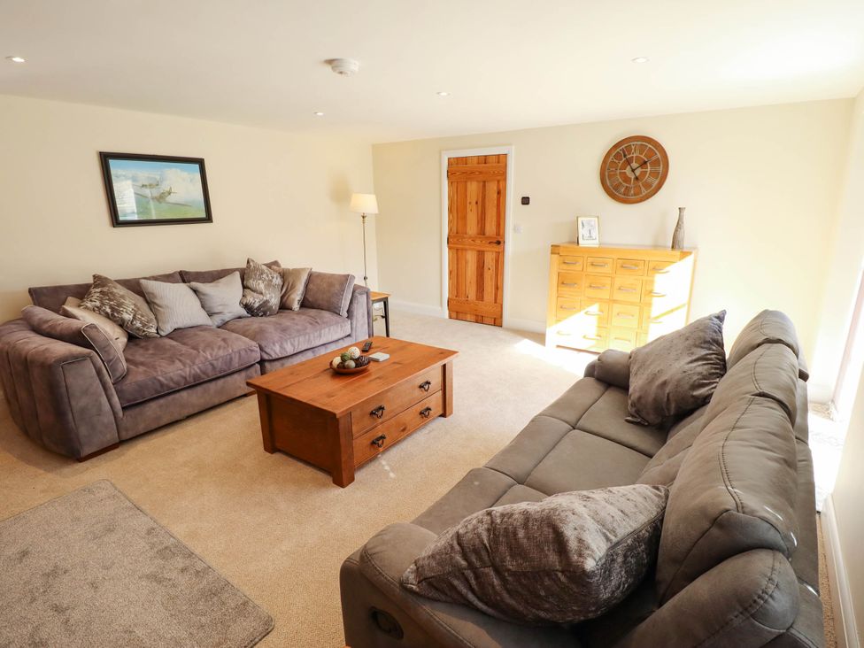 A living room with a coffee table and sofas at Three Chimneys in Scampton near Ingham