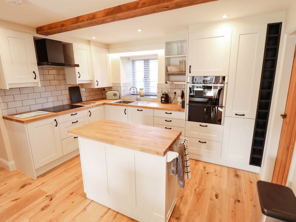 A kitchen with a countertop and island at Three Chimneys in Scampton near Ingham