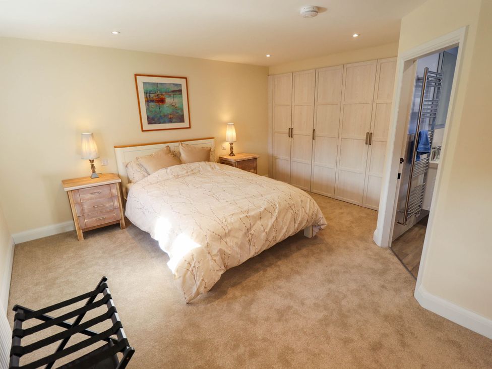 A bedroom with a bed and lamps at Three Chimneys in Scampton near Ingham