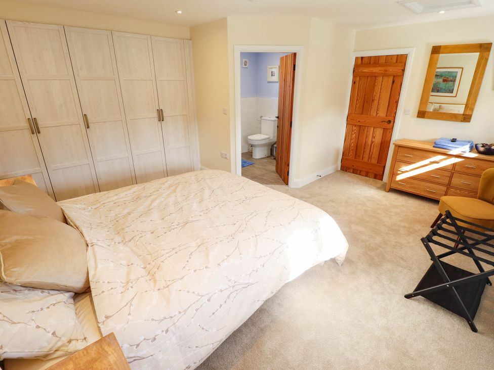 A bedroom with a bed and wardrobe at Three Chimneys in Scampton near Ingham