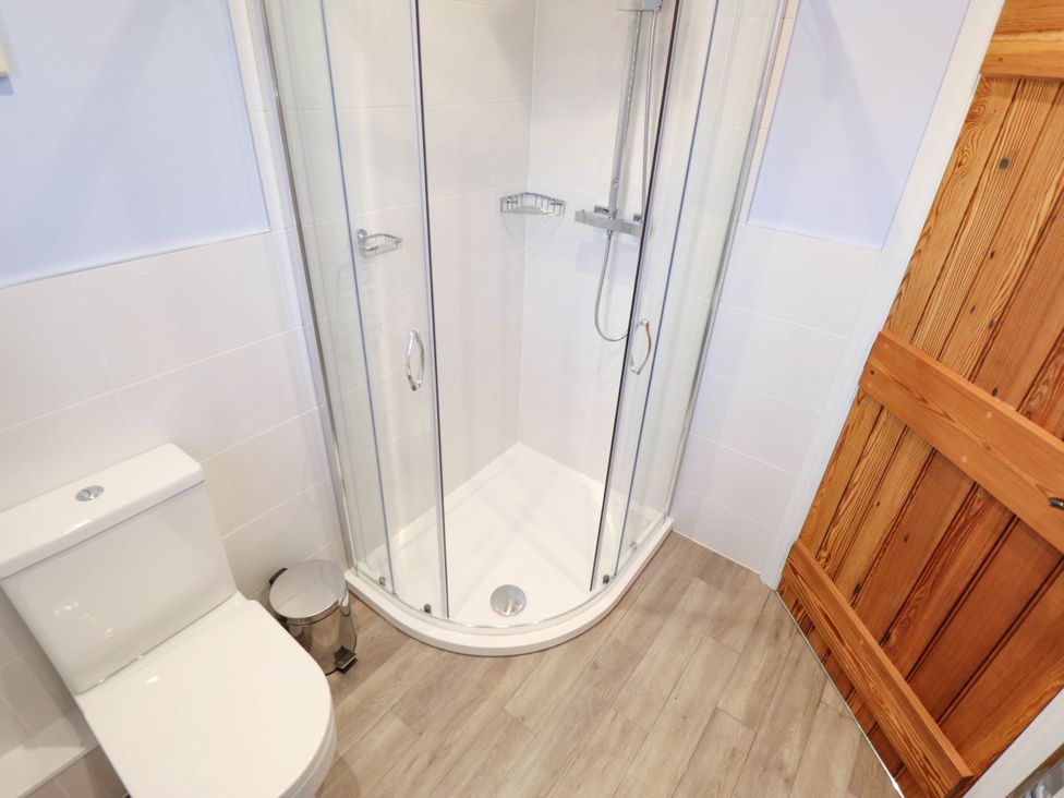A bathroom with a shower and toilet at Three Chimneys in Scampton near Ingham