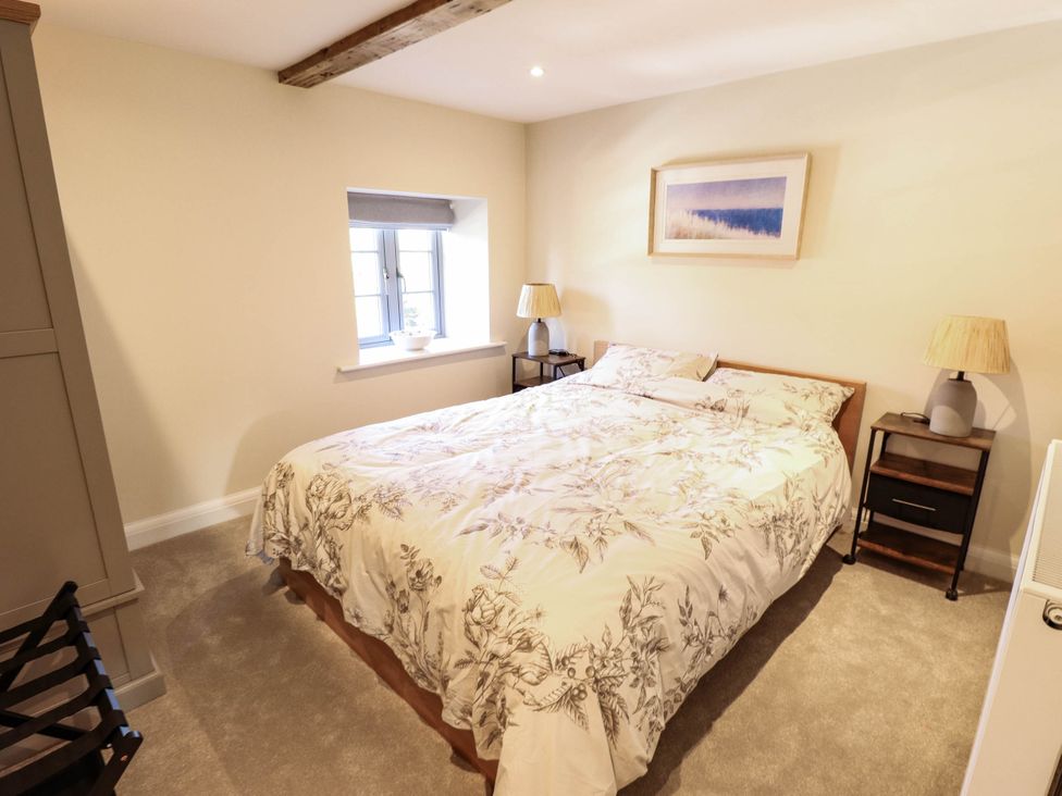 A bedroom with a bed and windows at Three Chimneys in Scampton near Ingham