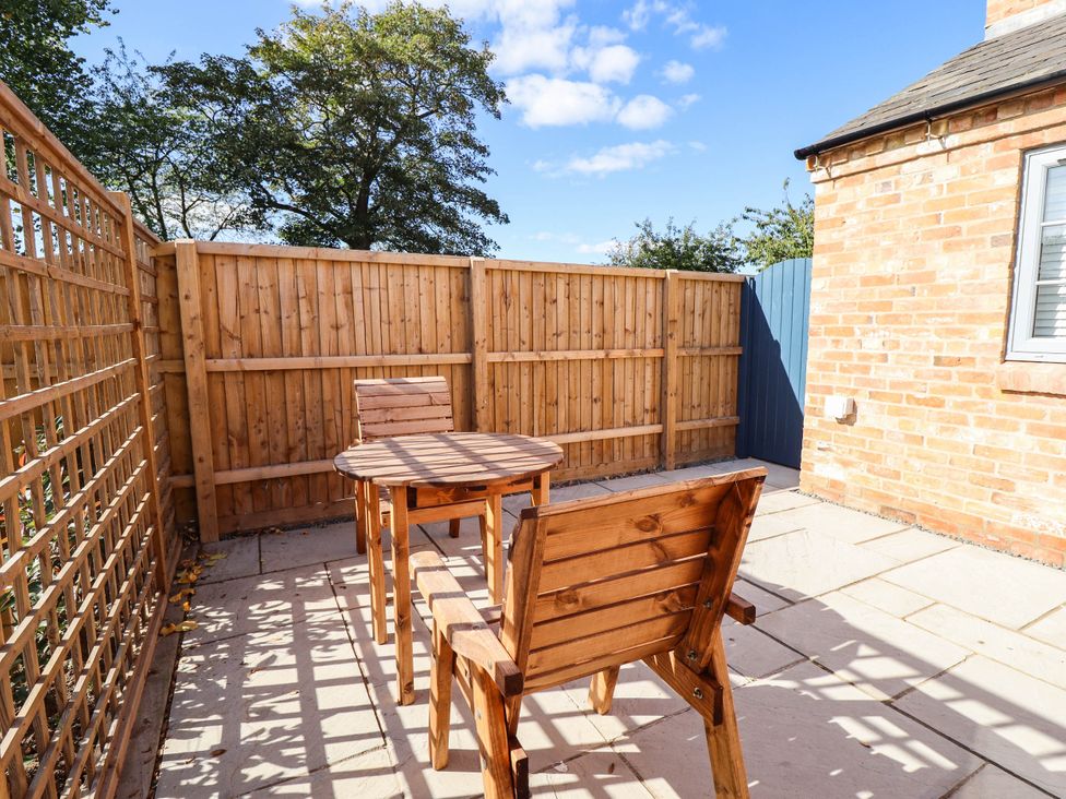 An outdoor patio with a table and chairs at Three Chimneys in Scampton near Ingham