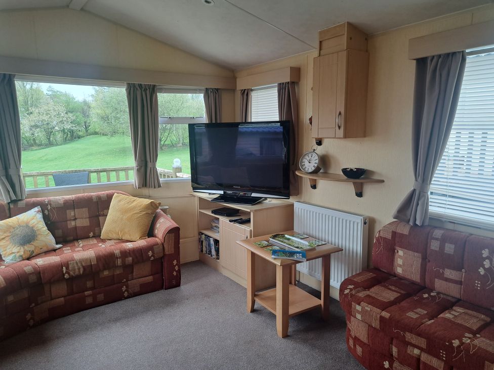 A living room with a TV and sofas at Chapel Farm Holiday Park No 6 Bunnies View in Appleby-in-Westmorland