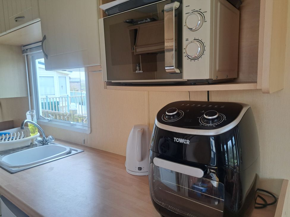A kitchen with a microwave and air fryer at Chapel Farm Holiday Park No 6 Bunnies View Appleby-in-Westmorland