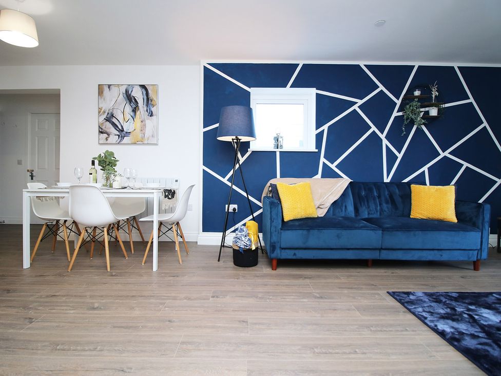 A living room with seating and dining area at 2 bed Cardiff city centre apartment Cardiff
