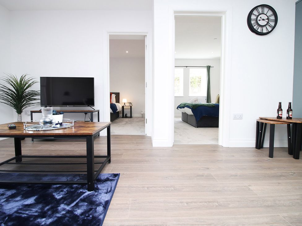 A living room with a television and coffee table at 2 bed Cardiff city centre apartment Cardiff