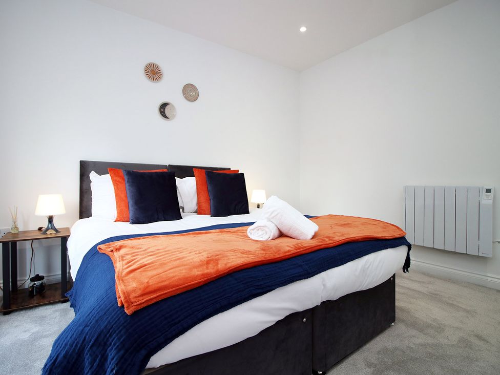 A bedroom with a bed and nightstand at 2 bed Cardiff city centre apartment in Cardiff