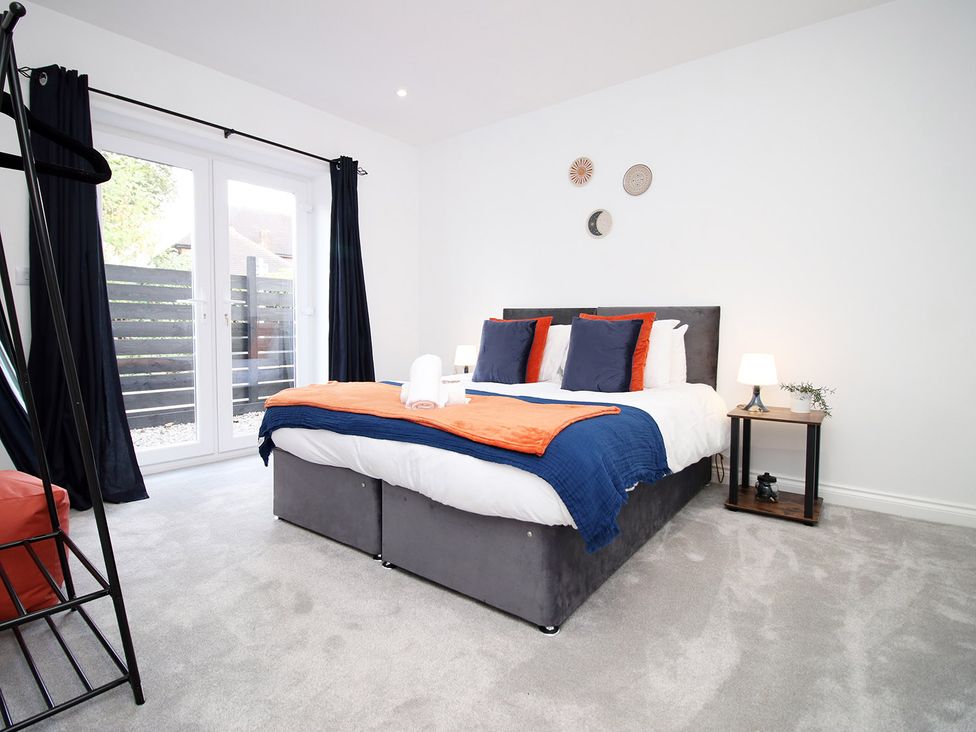 A bedroom with a bed and bedside table at 2 bed Cardiff city centre apartment in Cardiff