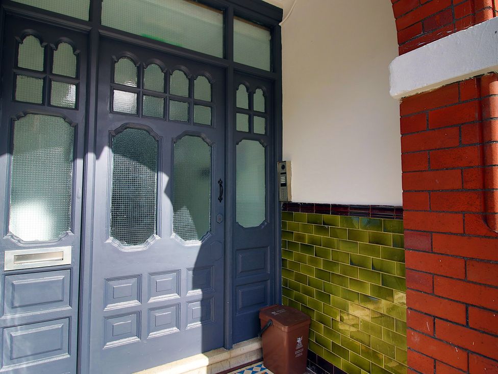 An entrance with a door and a bin at 2 bed Cardiff city centre apartment Cardiff