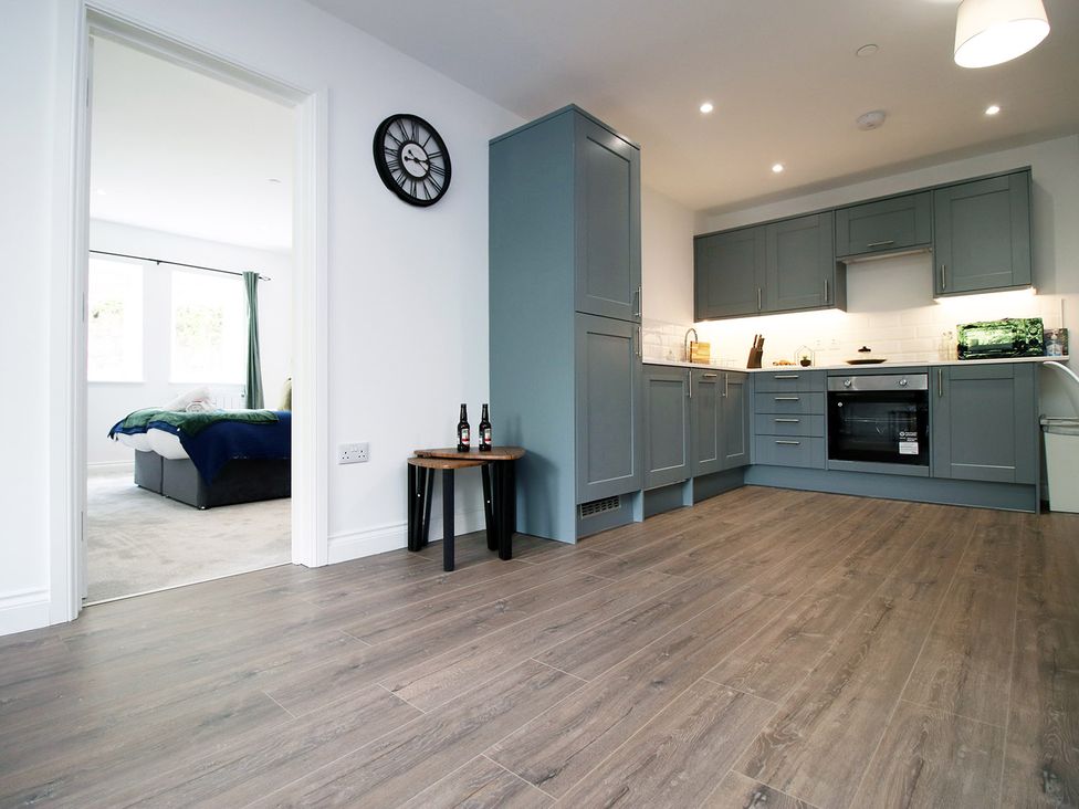 A kitchen with cabinets and an oven at 2 bed Cardiff city centre apartment Cardiff