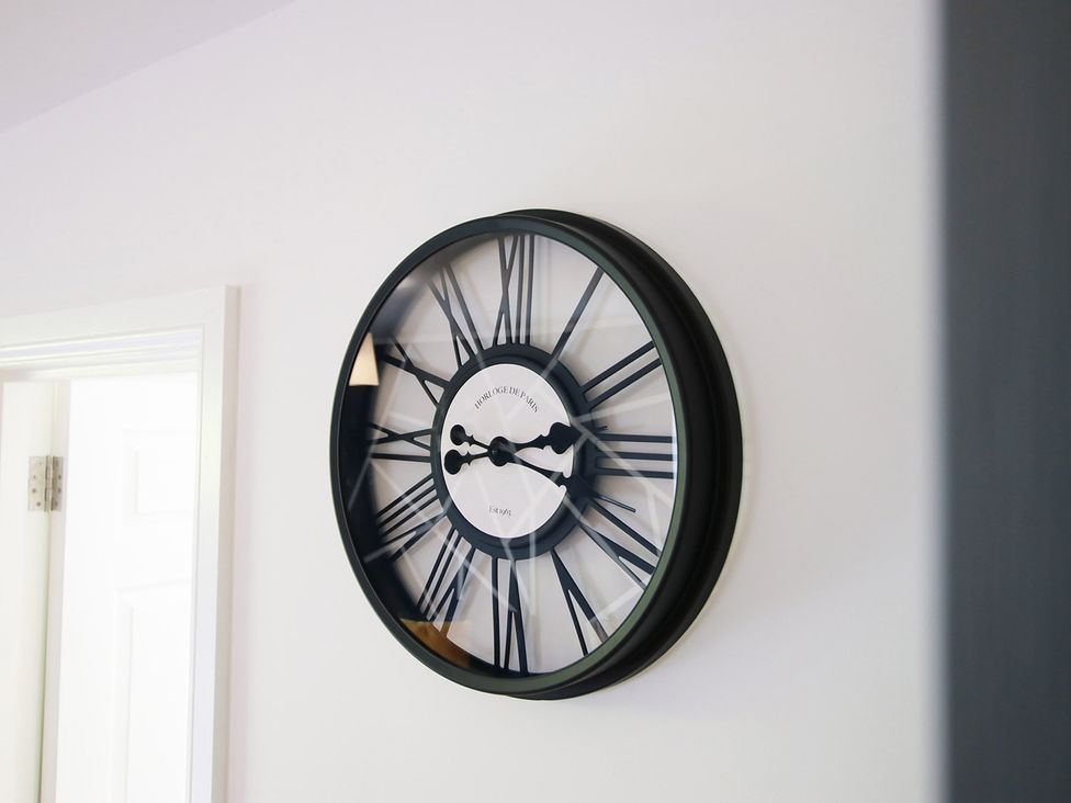 A clock on the wall at 2 bed Cardiff city centre apartment Cardiff