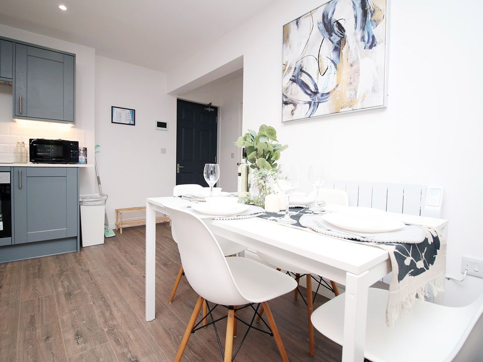 A dining room with a table and chairs at 2 bed Cardiff city centre apartment Cardiff