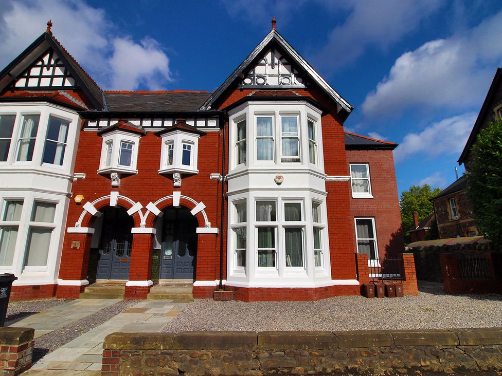 A building with multiple windows and doors in front yard at 2 bed Cardiff city centre apartment Cardiff