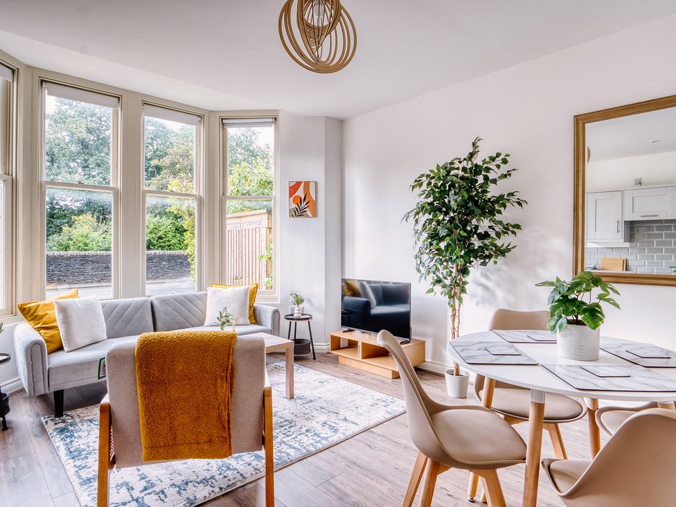 A living room with a sofa and dining table at Stunning 2 Bed by the City Centre and Bute Park Cardiff
