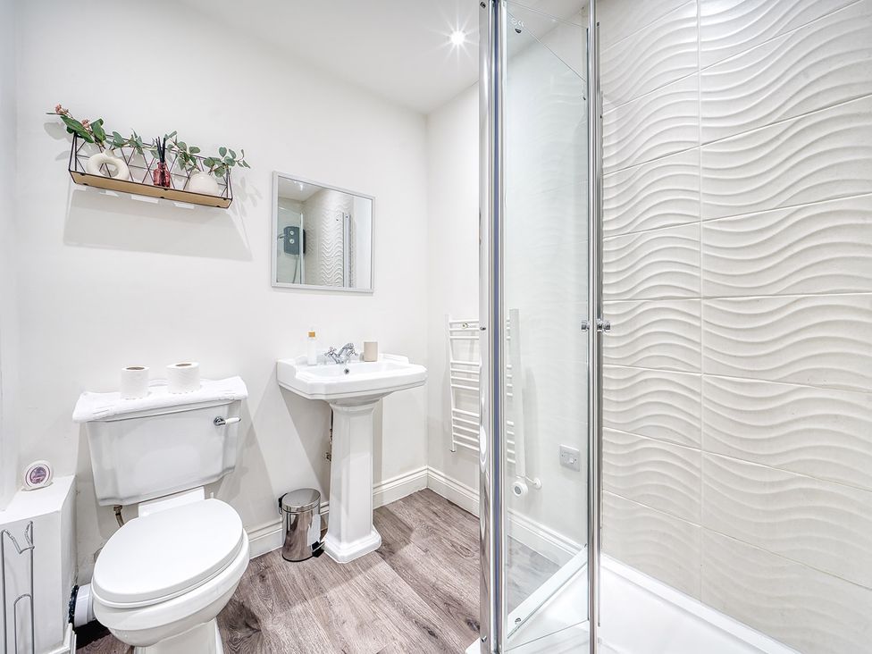 A bathroom with a toilet, sink, and shower at Stunning 2 Bed by the City Centre and Bute Park, Cardiff