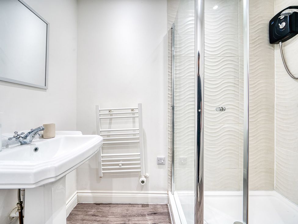 A bathroom featuring a sink, mirror, towel rack, and shower at Stunning 2 Bed by the City Centre and Bute Park, Cardiff