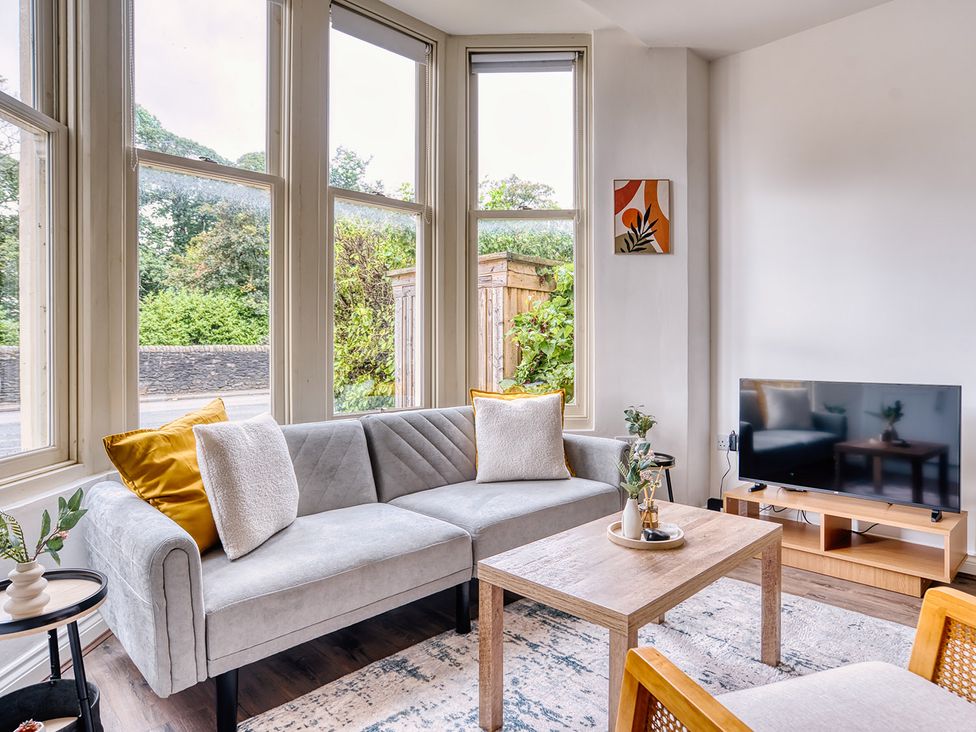 A living room with a sofa and television at Stunning 2 Bed by the City Centre and Bute Park, Cardiff