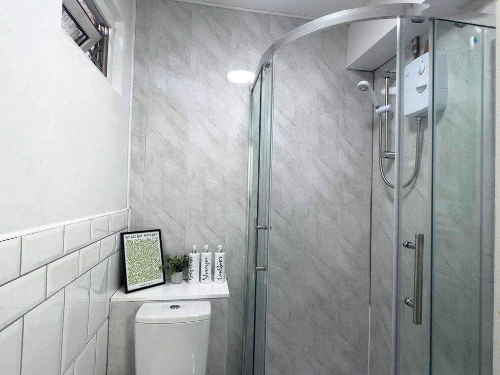 A bathroom with a shower and toilet at Ground Floor Apartment Sleeps 4 with Parking Cardiff