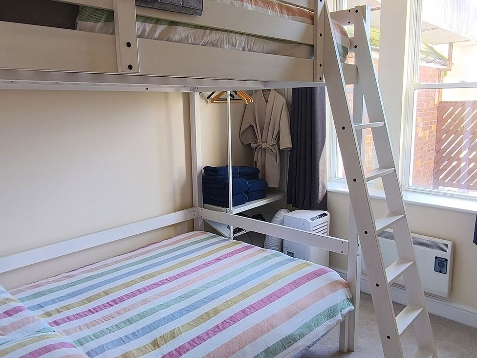 A bedroom with a bunk bed and towels at Cardiff Apartment, sleeps 6, Castle and Stadium nearby, Cardiff