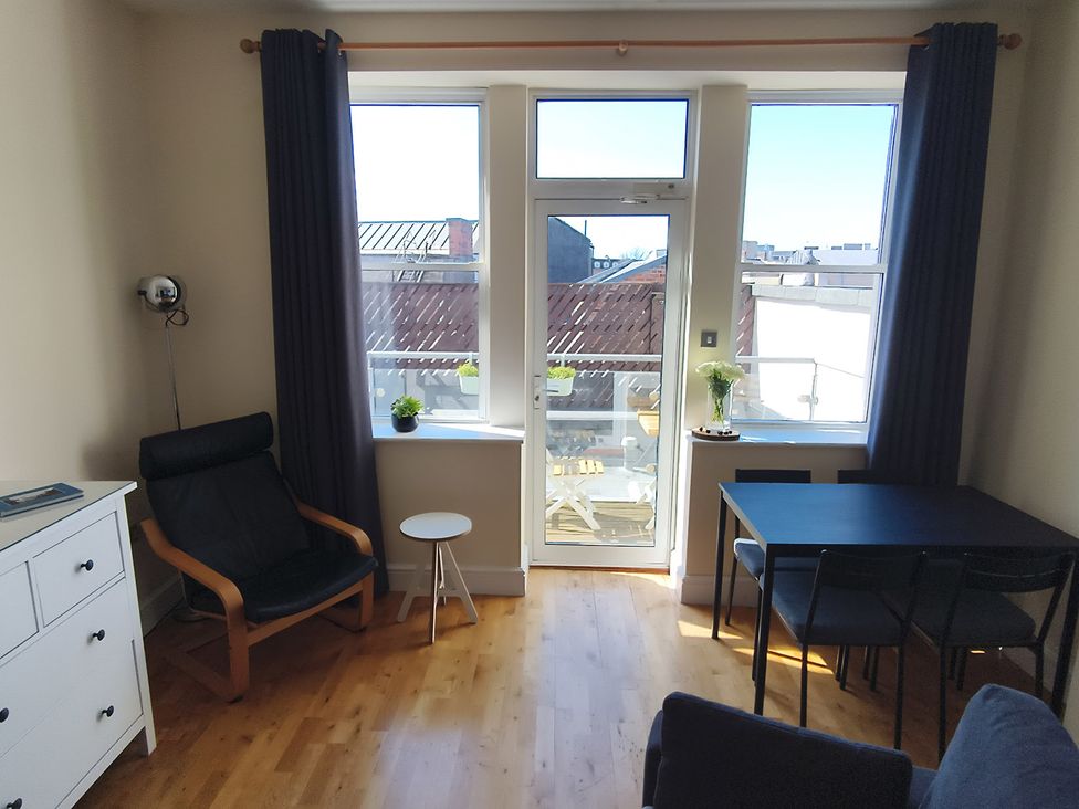 A living room with a table and chairs at Cardiff Apartment, sleeps 6, Castle and Stadium nearby Cardiff